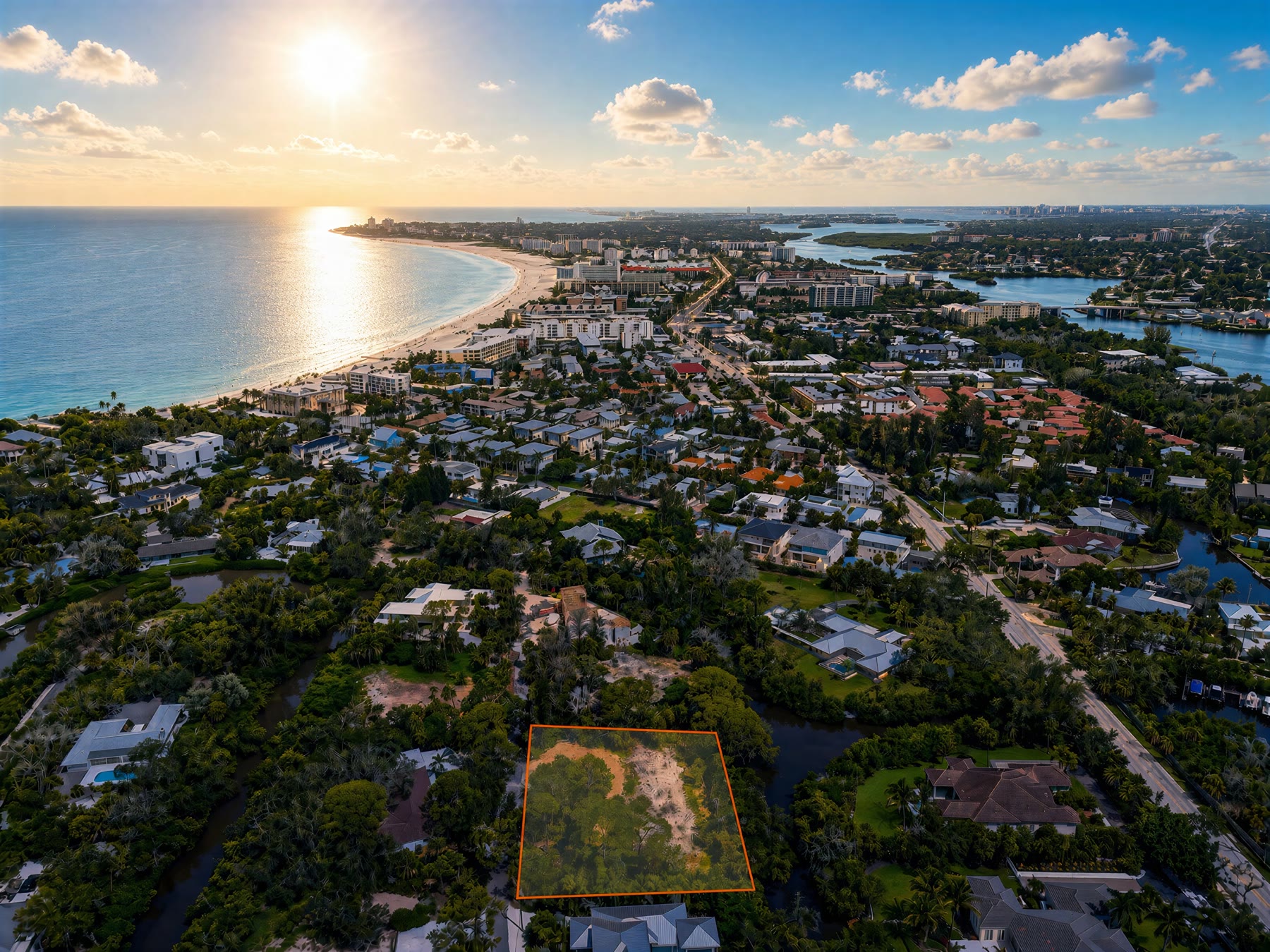 Aerial of a vacant coastal lot in daylight with the parcel outlined